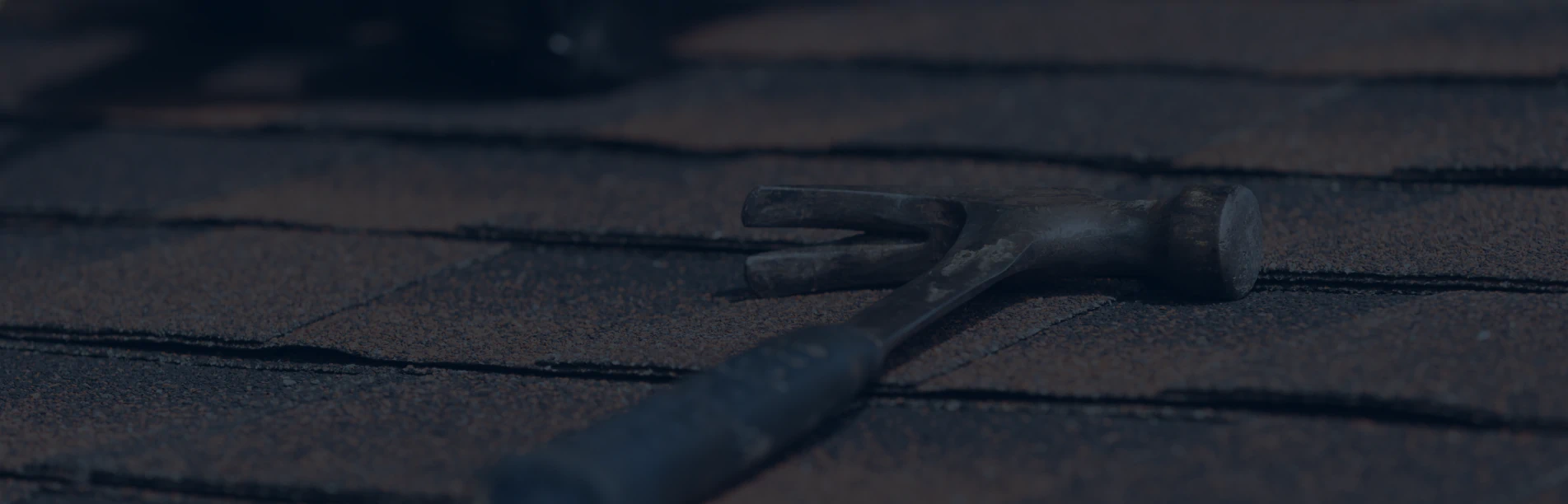 roof repair tools on asphalt shingles